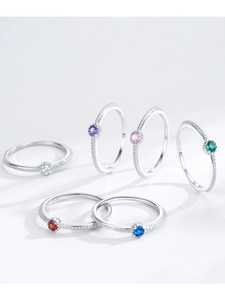 Macro detail of S925 sterling silver rings with colorful stones and milgrain texture