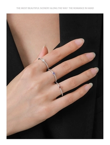 Detailed view of three minimalist S925 silver rings with colorful zircon on model's hand