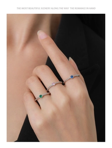 Detailed view of stacked S925 silver rings with green, pink and blue zircon gemstones