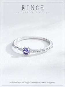 Close-up of S925 sterling silver ring with purple zircon and beaded edge detail