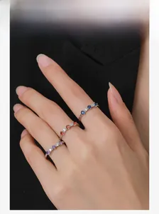 Close-up of S925 sterling silver rings with blue, red, and purple zircon in claw setting