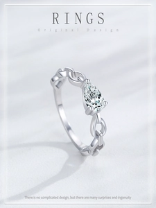 Macro detail of S925 silver chain ring with a pear-cut cubic zirconia stone