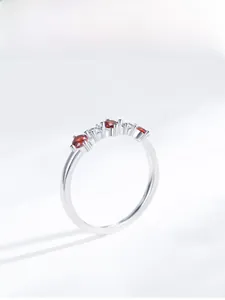 Detailed top view of S925 silver ring featuring ruby red stones and white zircons