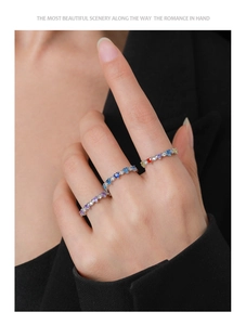 Macro shot of colorful heart gemstone rings in S925 sterling silver worn by a model