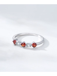 Macro detail of S925 silver ring with alternating red ruby and white zircon stones