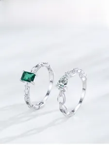 Macro detail of S925 silver chain rings with emerald zircon and pear cut crystal