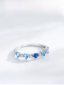 Detailed macro view of S925 silver ring featuring gradient blue heart-shaped gemstones