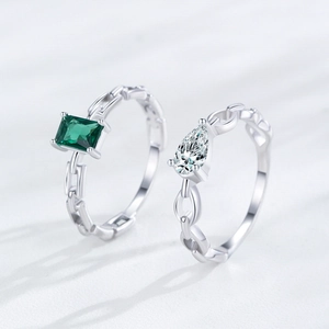 S925 sterling silver ring set featuring emerald cut green stone and pear-shaped zircon