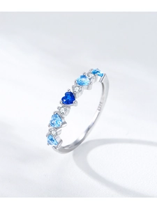Macro shot of S925 sterling silver ring with blue heart gemstone and tiny white diamonds