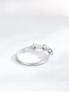 Close-up of S925 sterling silver ring with purple zircon stones and elegant engraving