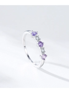 Detail of silver S925 ring featuring purple and white zircon stones in a claw setting