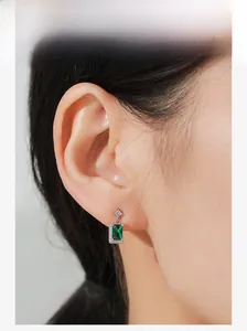 Close-up of vintage S925 silver earring featuring a rectangular green zircon stone