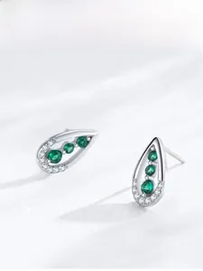 Detailed view of silver teardrop earrings featuring green zircon and white micro-diamonds