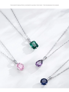 Macro shot of 925 silver necklaces with colorful geometric zircon stone pendants