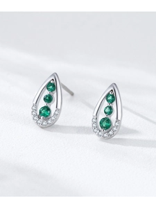 Detailed macro view of 925 sterling silver teardrop earrings with green zircon stones