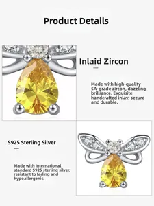 Gros plan d'une boucle d'oreille papillon en argent S925 avec zircon jaune poire