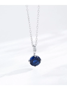 Close-up of S925 sterling silver necklace with a round deep blue sapphire pendant