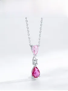 Detailed view of silver necklace featuring tiered pink and rose red pear-cut crystals