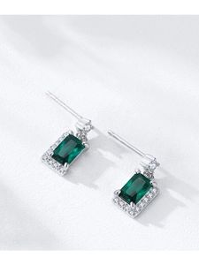 Macro view of S925 silver emerald-cut green zircon earrings with diamond halo design