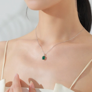 Elegant 925 sterling silver necklace with emerald cut green zircon on a model's neck