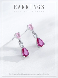 Detail of S925 silver earrings with pink and rose pear-cut stones in three-stone design