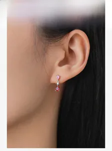 Detailed close-up of S925 silver pink teardrop earrings worn by a model in soft light