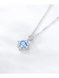 Macro detail of S925 silver necklace with blue zircon sunflower pendant in close-up view