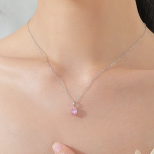 925 silver necklace featuring an oval pink gemstone pendant worn on a model neckline