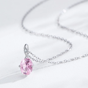 925 silver necklace with oval pink zircon pendant and silver chain in macro view