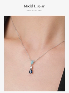 Detail of S925 silver necklace featuring a gradient blue teardrop pendant on model