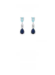 Macro detail of S925 silver earrings with light and dark blue teardrop-shaped zircons