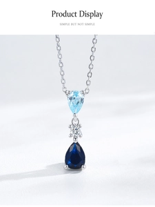 Macro detail of S925 silver necklace with blue teardrop zircon stones and polished chain
