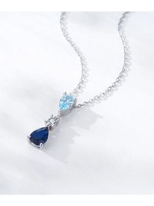 Macro view of S925 silver necklace with blue teardrop pendants and sparkling zircons