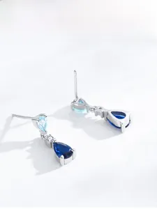 Detail of S925 sterling silver drop earrings with layered blue pear-cut zircon crystals