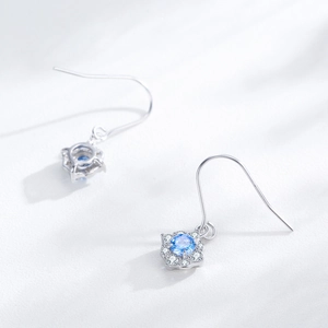 S925 sterling silver drop earrings with sea blue zircon flower pendant on white background