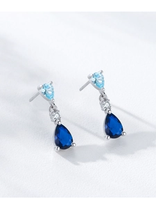 Detail of S925 sterling silver drop earrings featuring blue teardrop zircons and fine polish