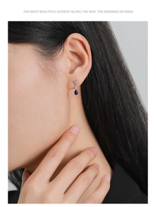 Detail of S925 silver drop earrings featuring blue stones and white zircon stones