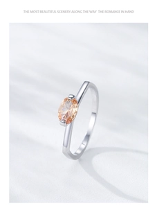 Macro shot of S925 silver ring with oval champagne zircon on water ripple background