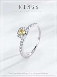 Detail of S925 silver ring featuring a yellow cushion-cut zircon with halo diamond setting
