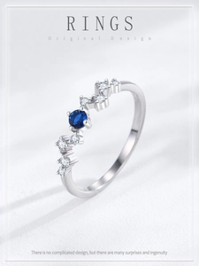 Macro view of wave design S925 silver ring with sapphire and white zircon stones