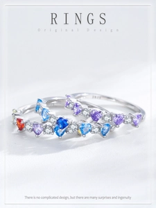 Macro shot of three stacked S925 silver rings with colorful heart-shaped zircon stones