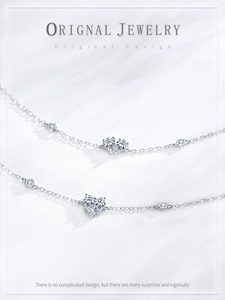 Macro detail of S925 silver heart bracelet with cubic zirconia inlays and refined chain