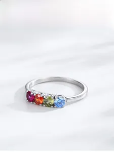 Macro detail of S925 silver ring featuring four colorful round-cut rainbow zircons