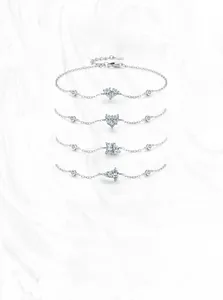 Detail of four S925 sterling silver bracelets with heart and geometric zircon charms