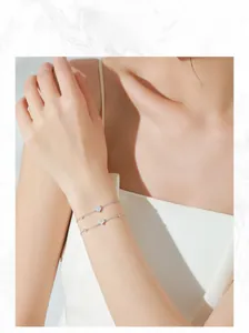Close-up of double-layer S925 silver bracelet featuring heart-shaped zircon charms