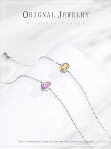 Macro detail of S925 silver bracelet featuring pink pear and yellow oval zircon stones