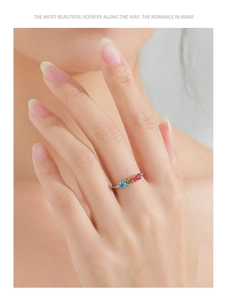 Close-up of S925 silver ring with colorful rainbow zircon stones on model finger