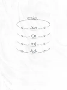 Macro view of S925 silver bracelets with Love and butterfly pendants and zircon stones