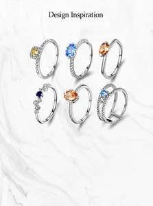 Macro shot showing diverse S925 silver rings with colorful zircon in various geometric designs