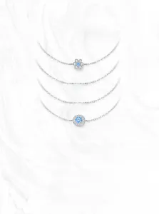 Detailed view of S925 silver bracelets with blue stones on marble background